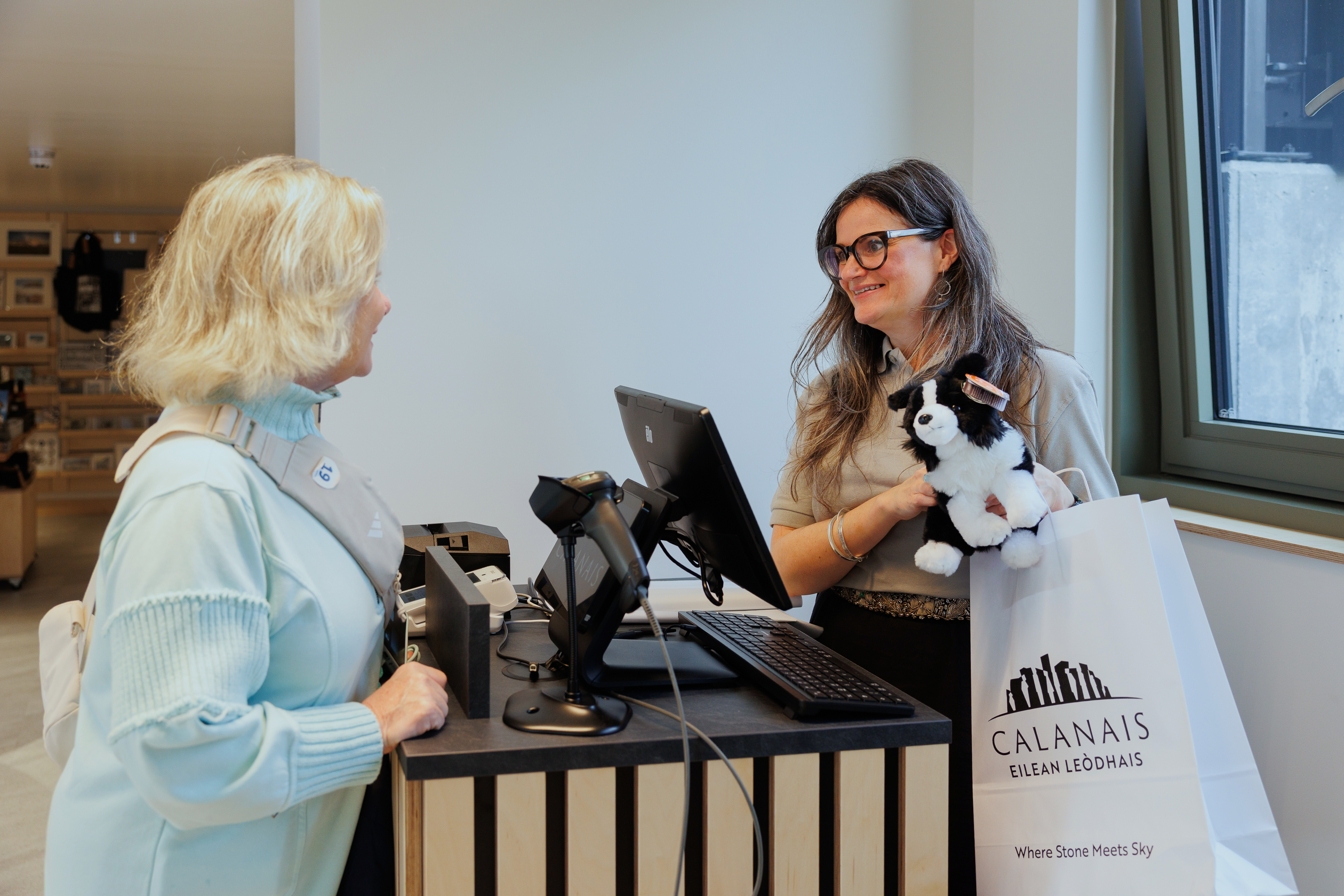 Calanais staff serving a visitor at the till